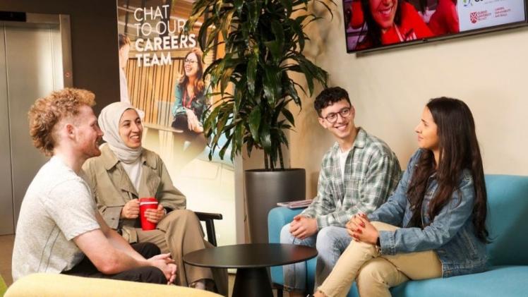 students sitting at a table chatting